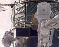 During the second spacewalk Claude Nicollier, ESA, (right) is inserting the Fine Guidance Sensor into Hubble. Michael Foale (left) is assisting.