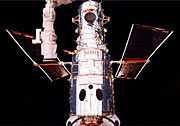 Hubble after capture with the remote manipulator arm. Ready for surgery!