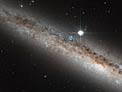A spiral galaxy crowned by a star