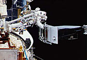 The 280 kg Wide Field Planetary Camera is easily lifted by the astronauts in the weightless environment of space.